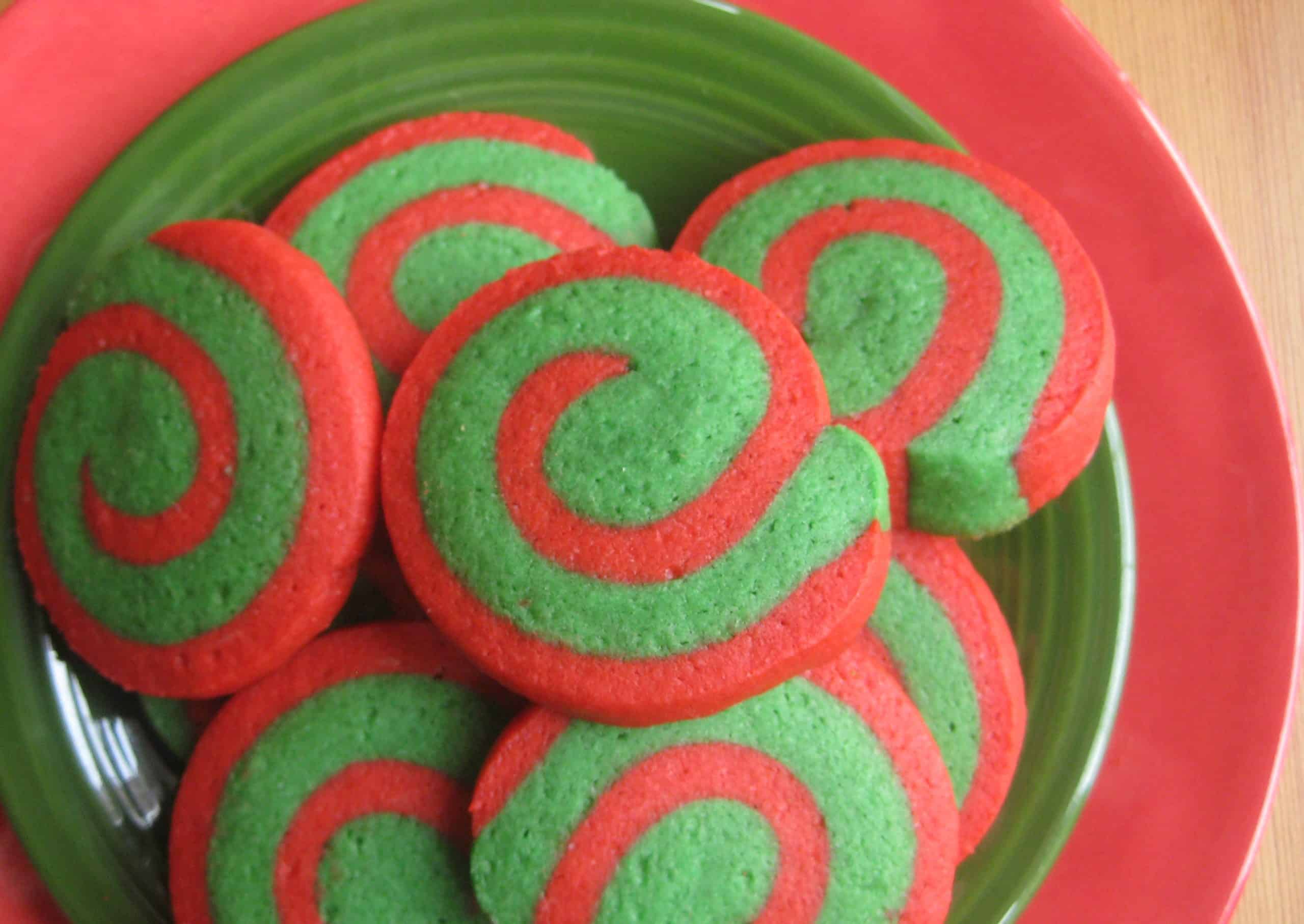 pinwheel cookies on a red and green plate