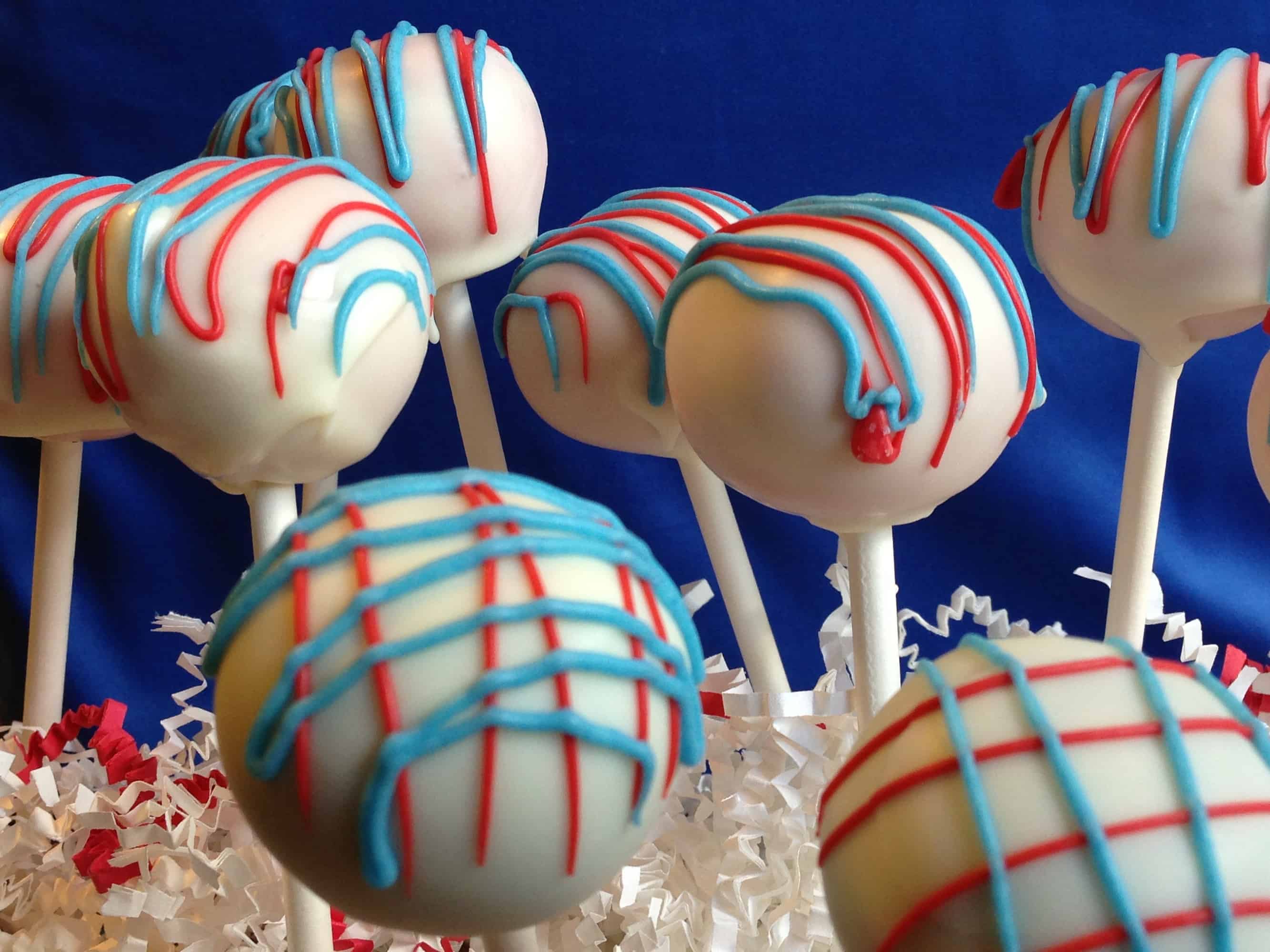 closeup of cake pops with red and blue decorations
