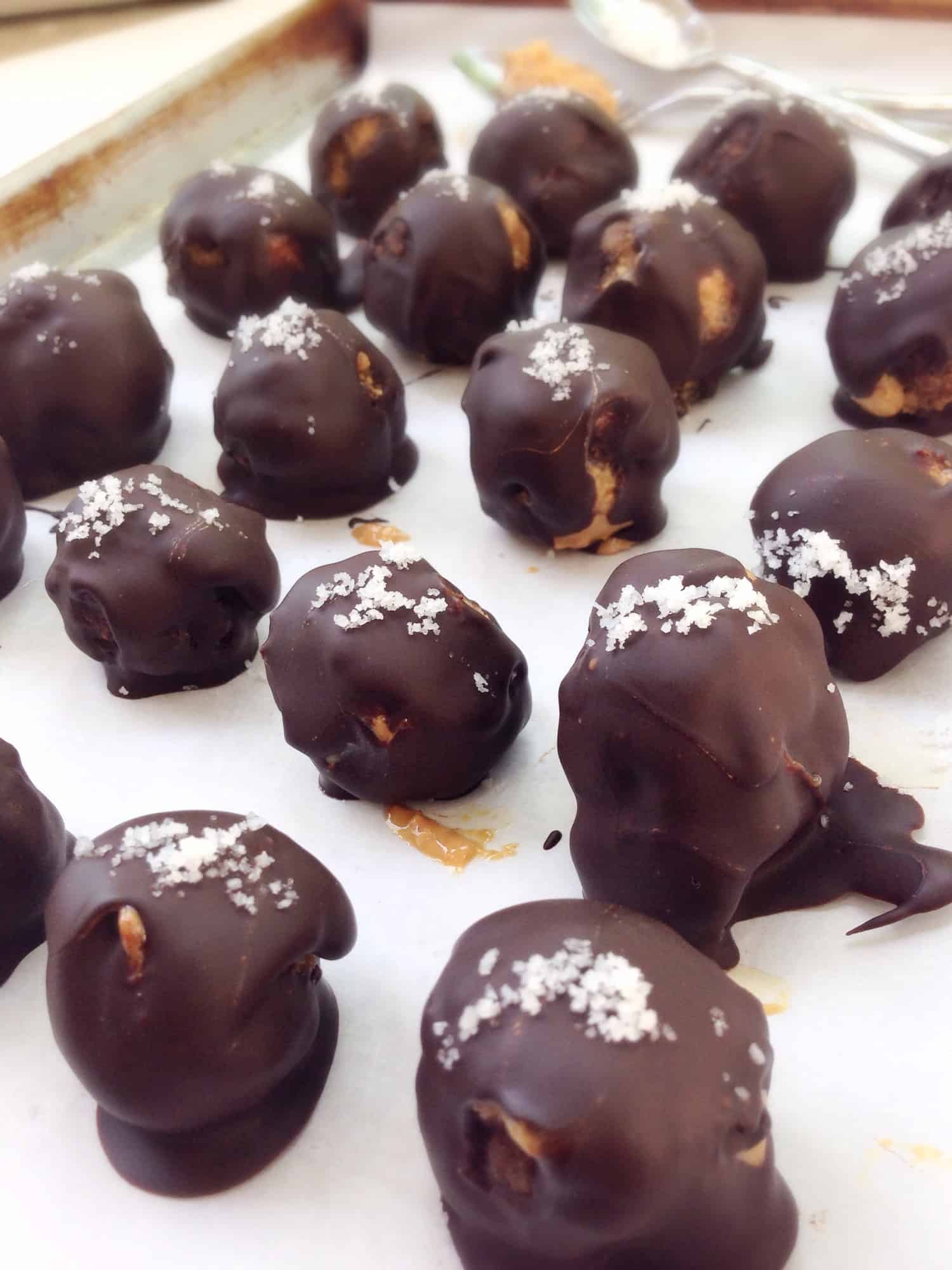 chocolate truffles sitting on a baking sheet