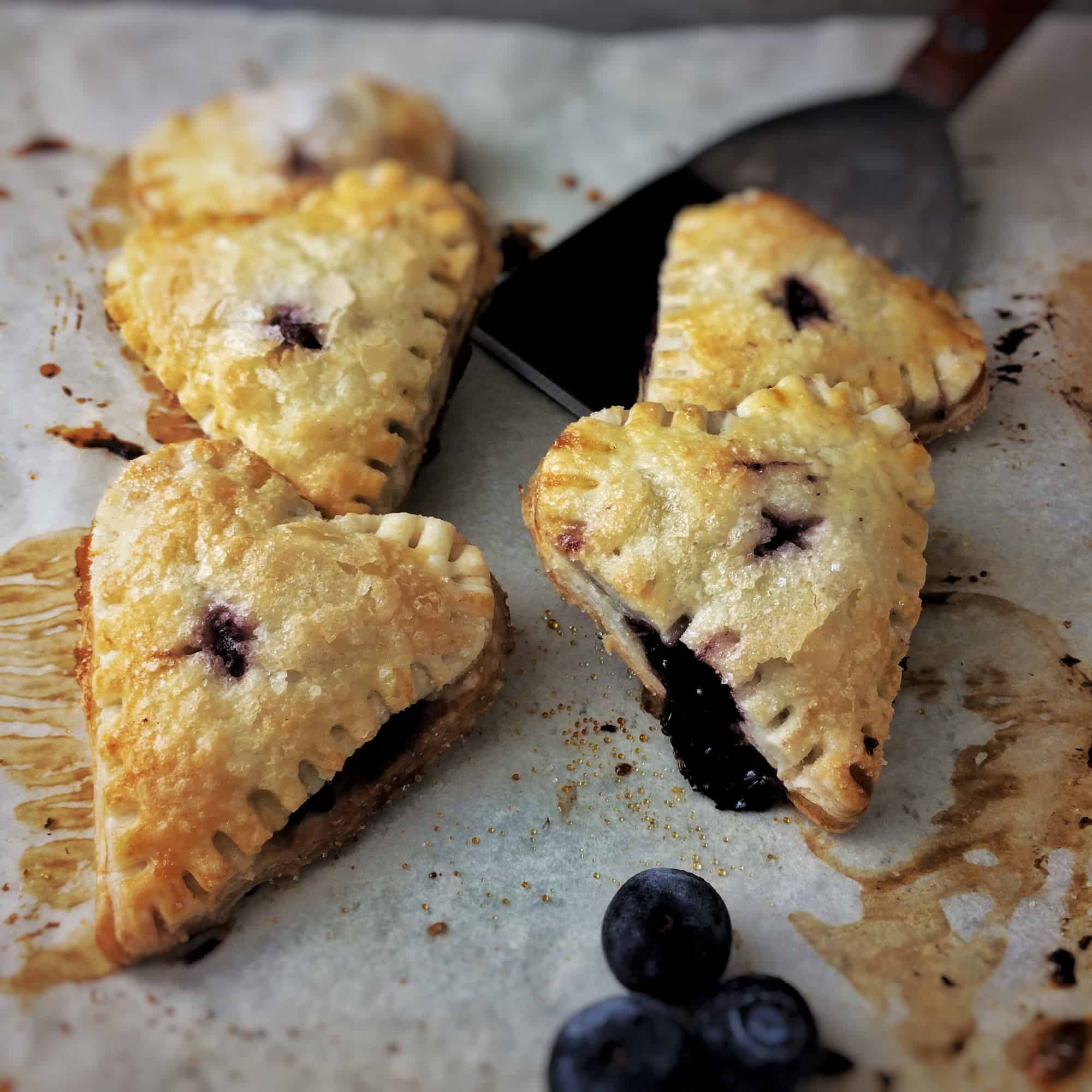 blueberry hand pies with a little blueberry filling oozing out of the corner