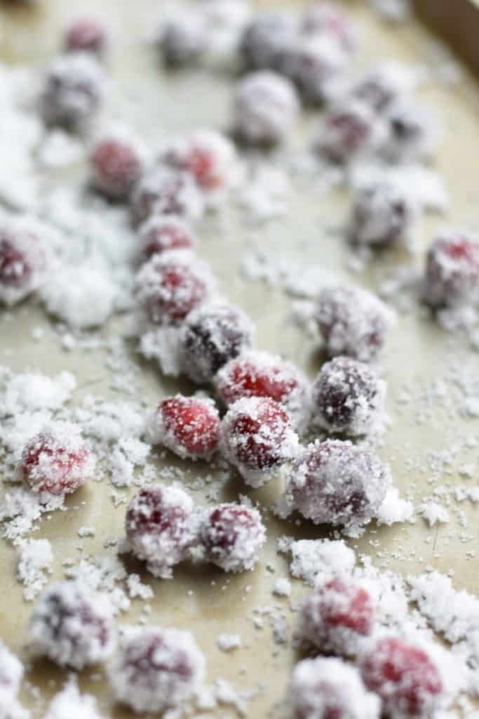 closeup of candied cranberries on a cookie sheet