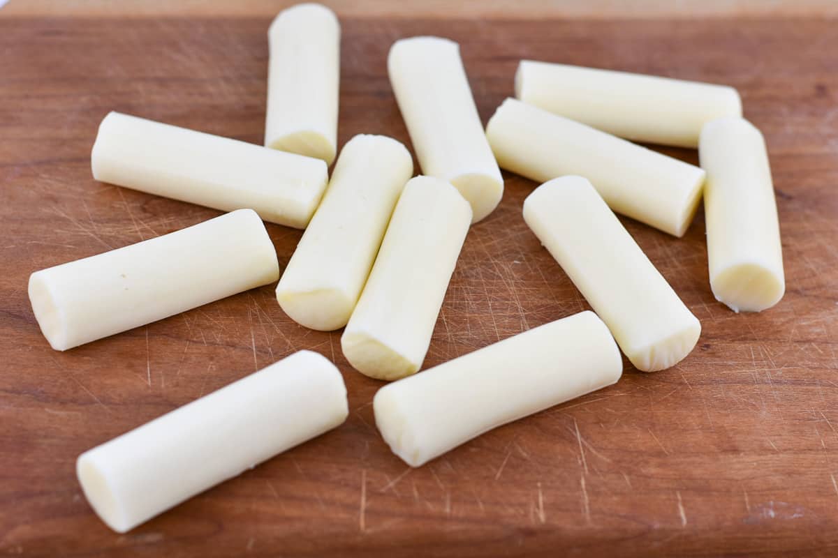mozzarella cheese sticks on a cutting board