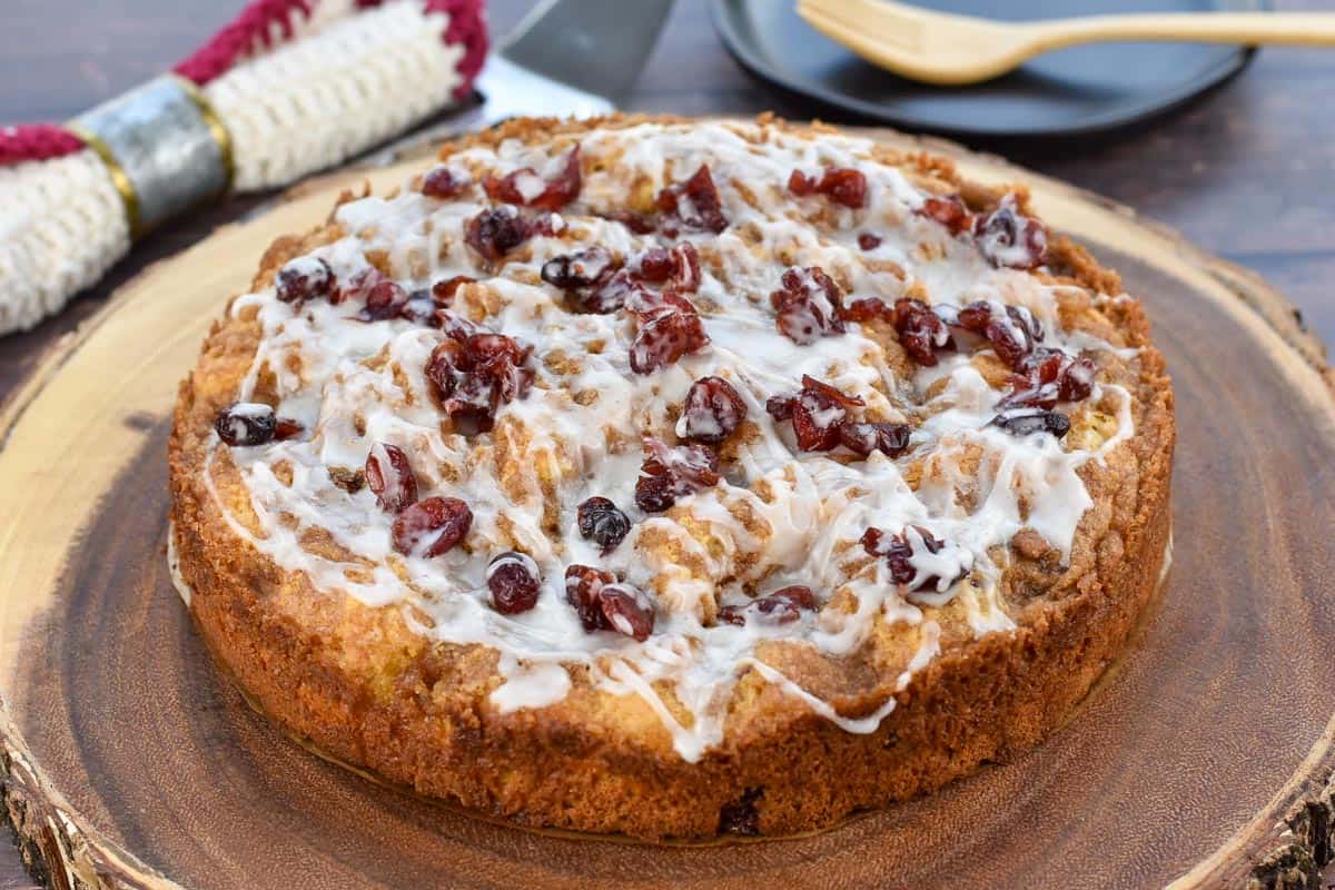 dried cranberry coffee cake sitting on a platter