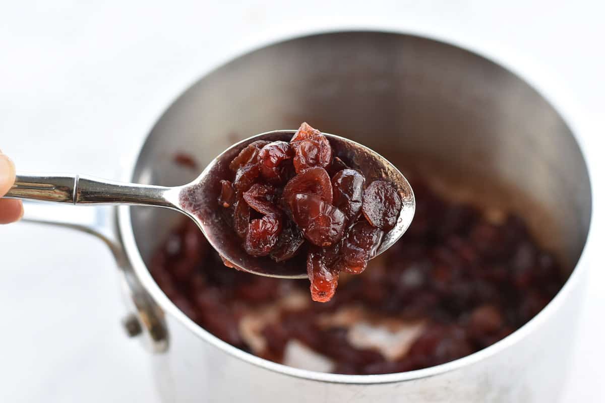 closeup of rehydrated cranberries on a spoon