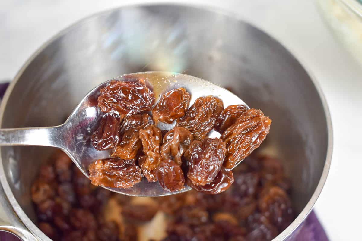 closeup of raisins rehydrated in pan