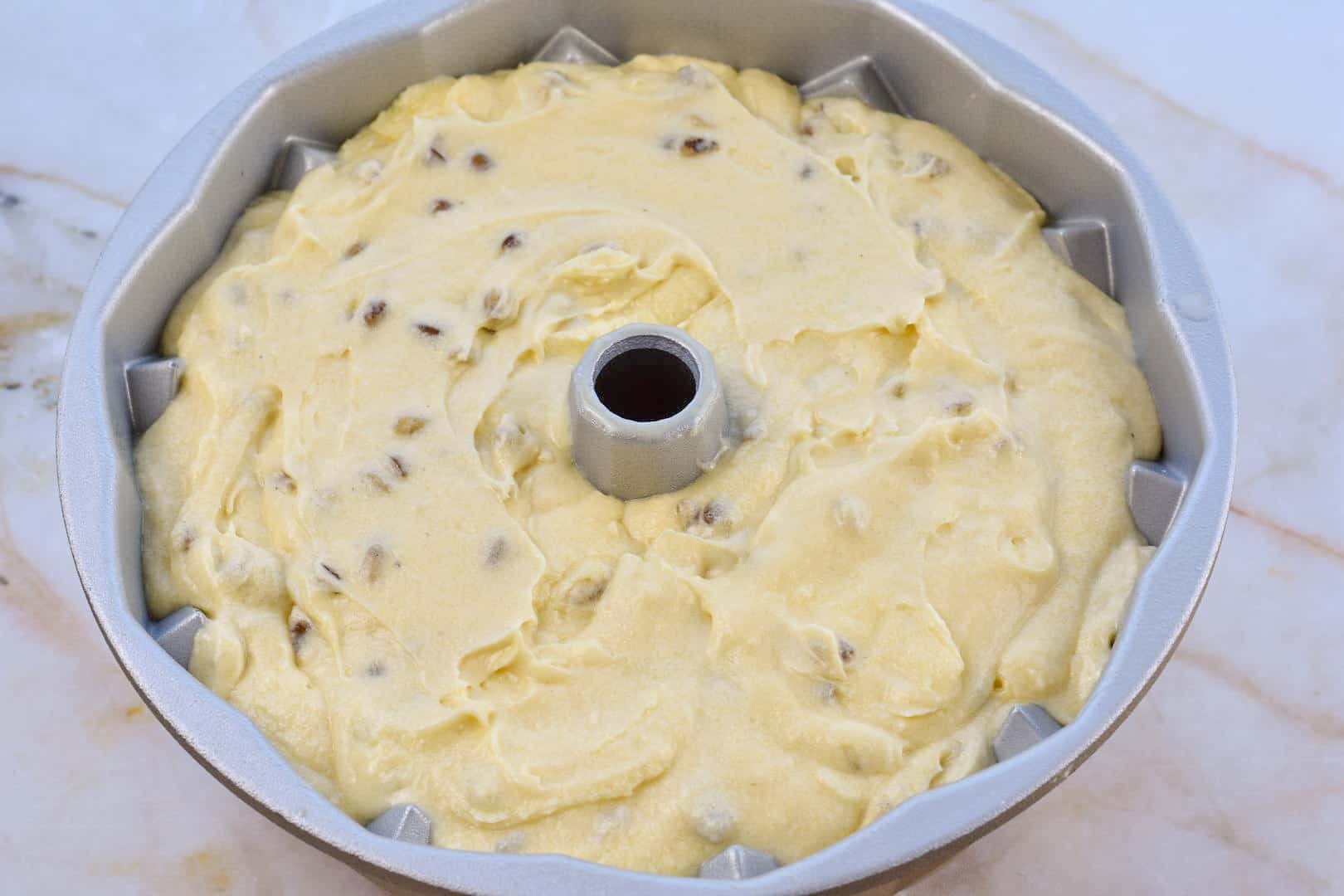 cake batter in bundt pan before baking