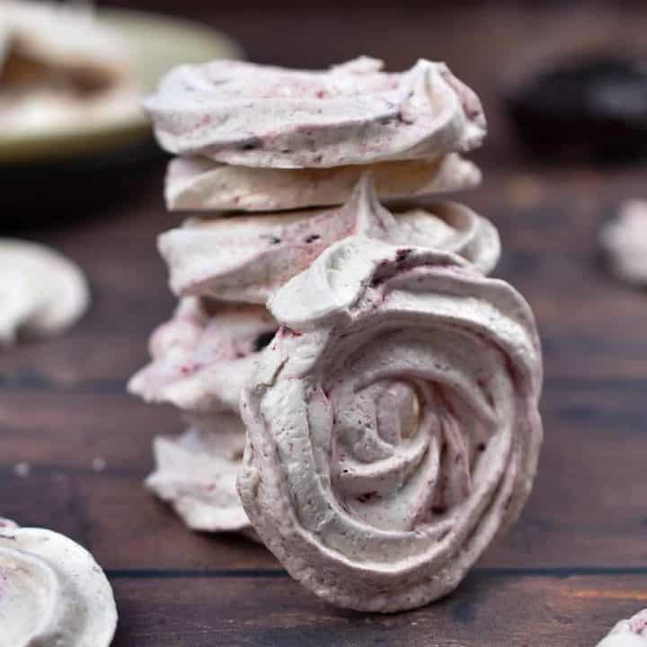 closeup of meringue cookies stacked on top of each other.