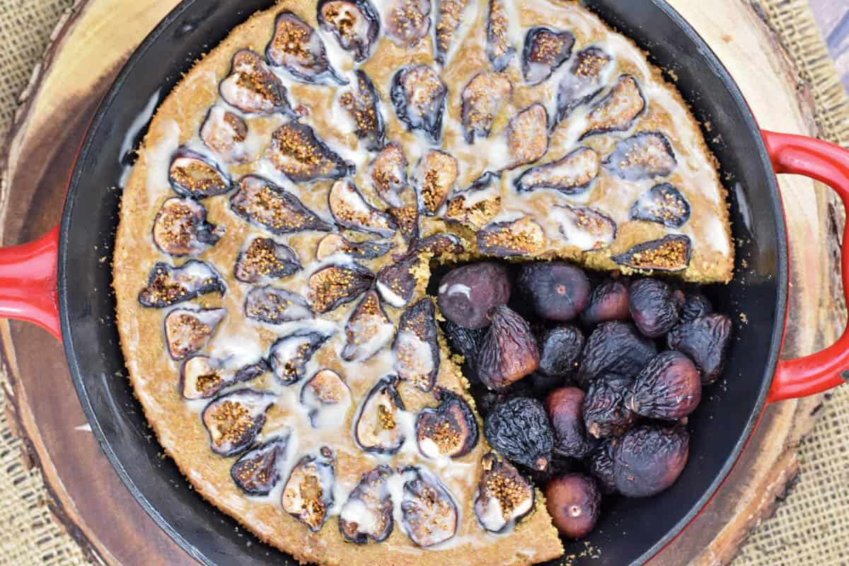 overhead shot of glazed cake with figs filling in a slice.