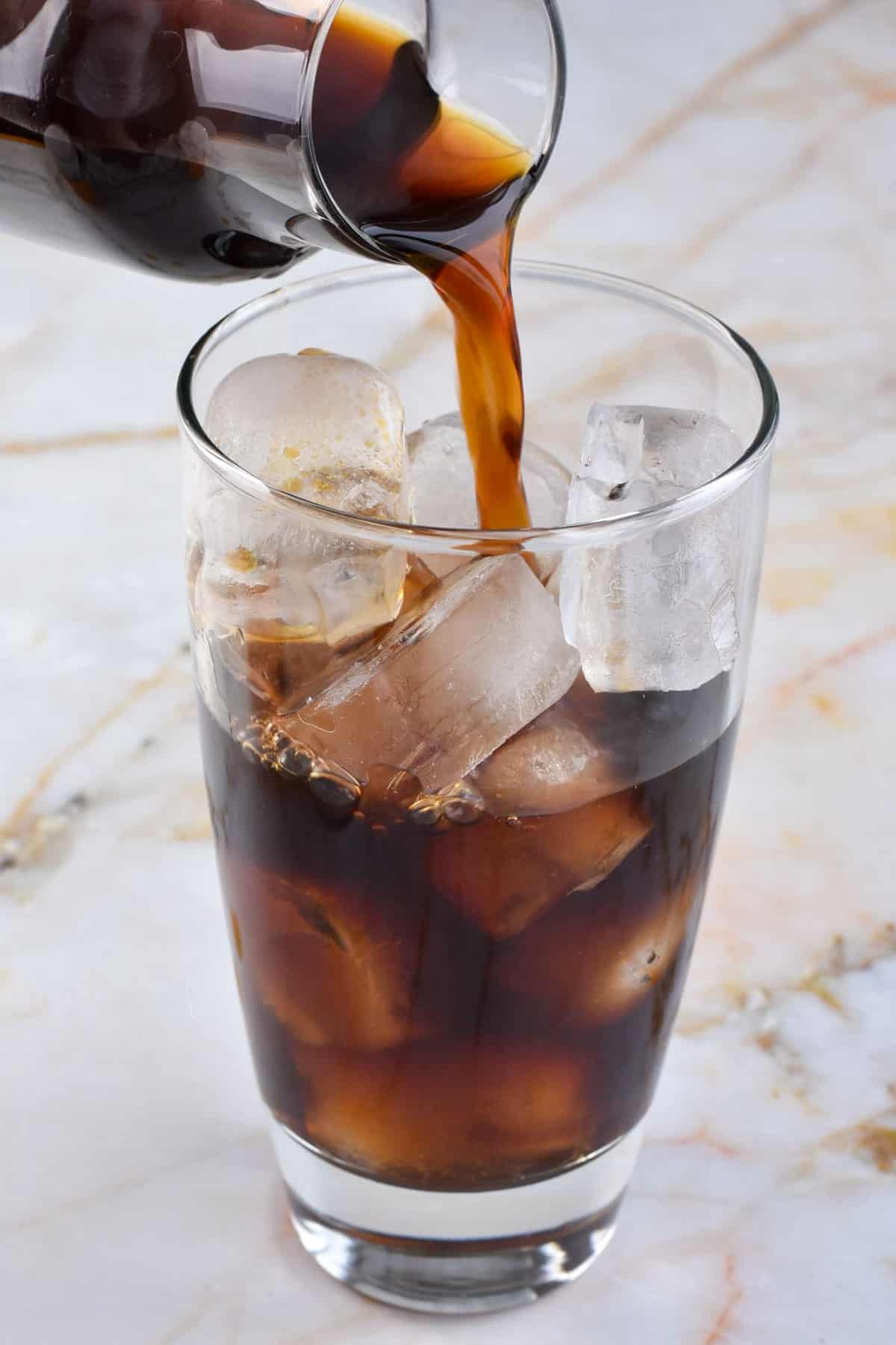 closeup of cold brew being poured into a glass