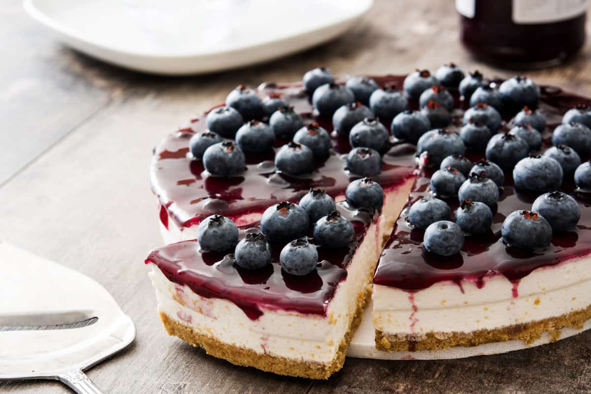 blueberry cheesecake with a slice on a platter