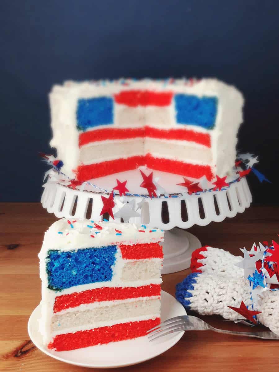 flag cake sitting on a platter in a piece standing up on a plate