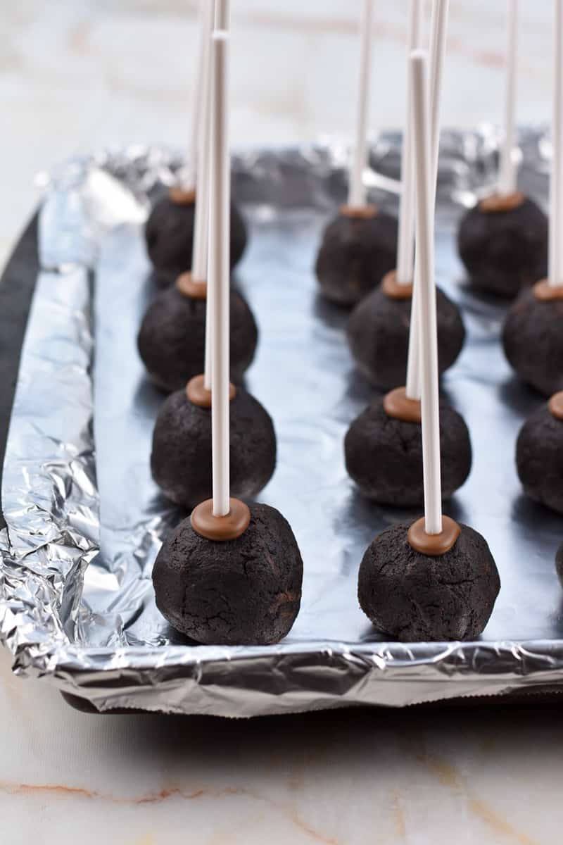 cake pops with chocolate securing the stick