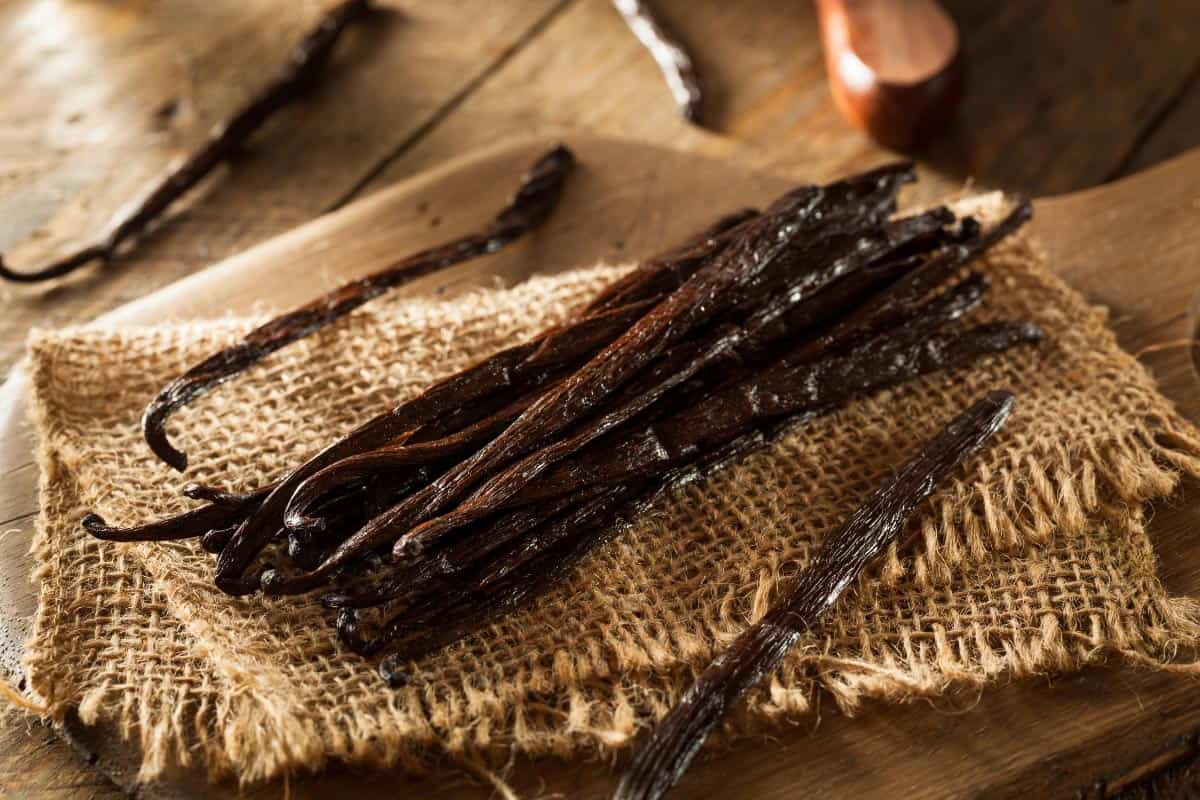 vanilla beans stacked on top of burlap.