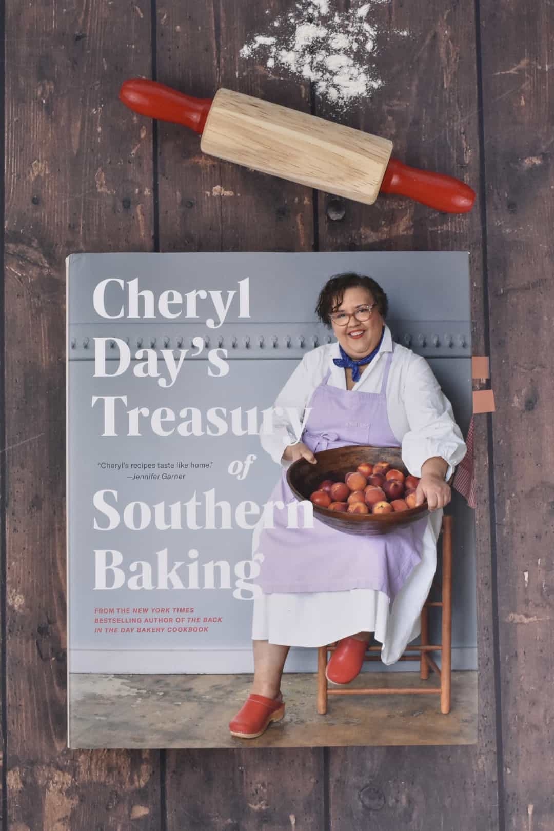 Cheryl Day's cookbook on a wooden counter with a rolling pin and flour. 