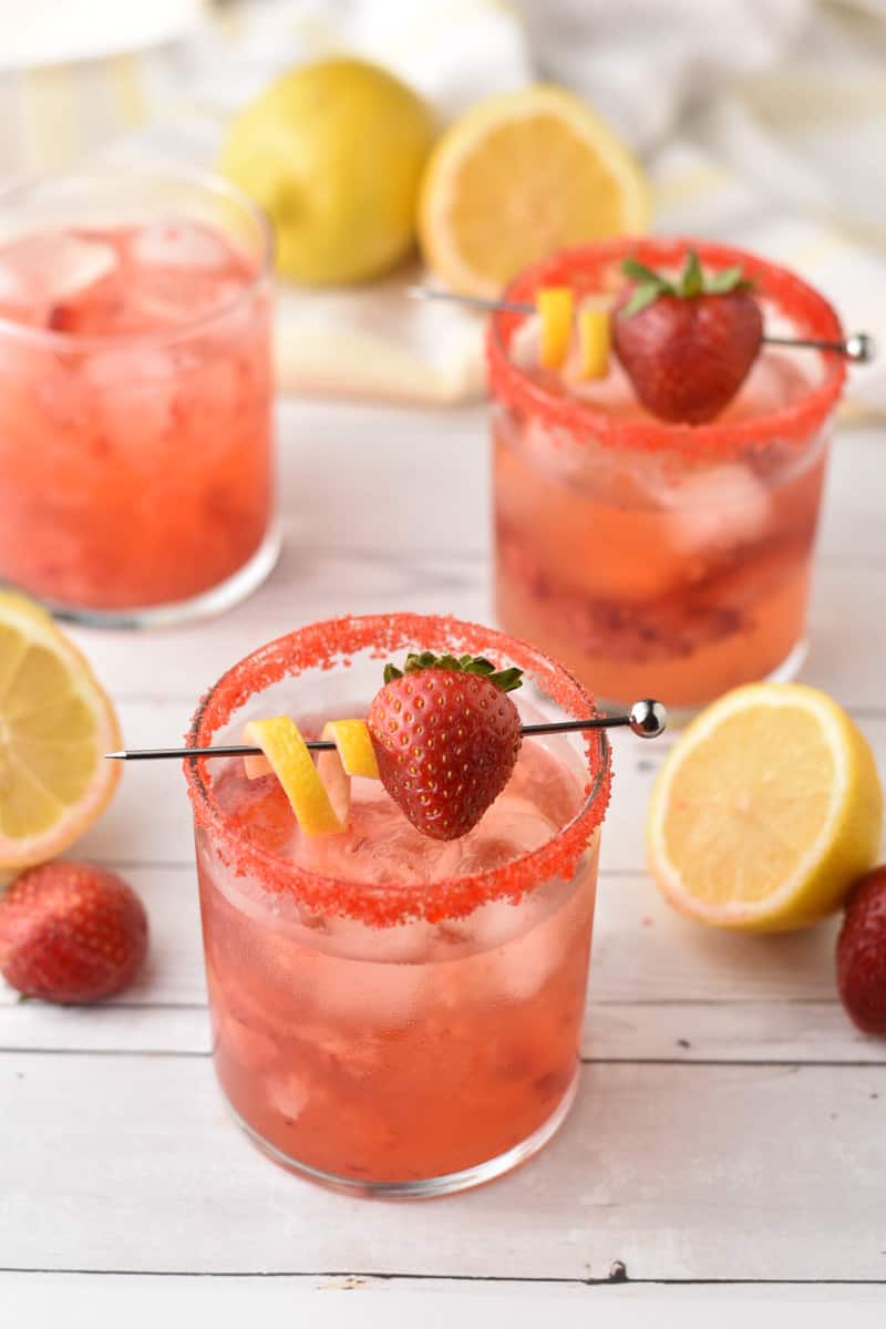 strawberry lemonade vodka in clear glass with garnish.