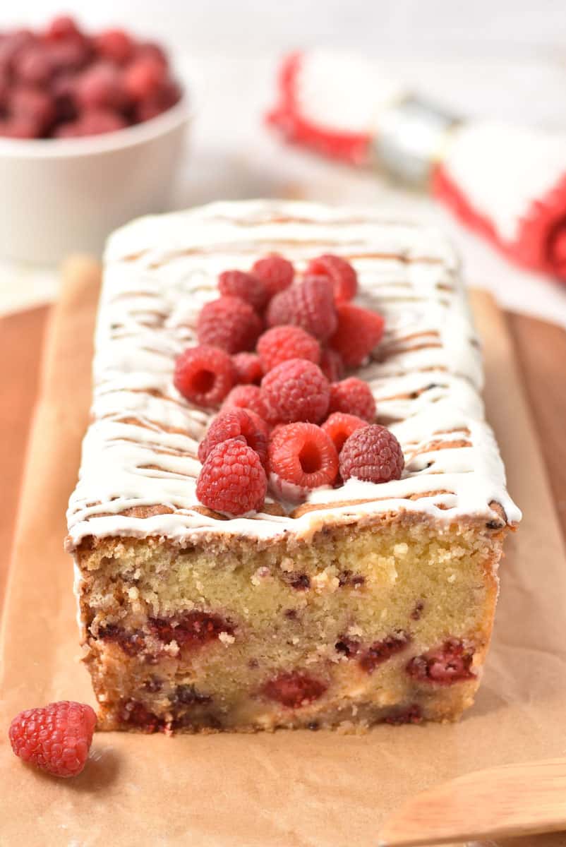 raspberry white chocolate loaf cake on parchment.