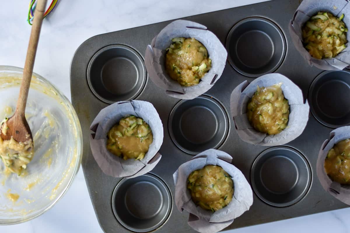 zucchini applesauce muffin batter in liners.