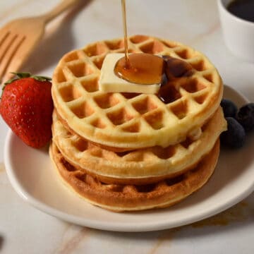 waffles with butter and syrup drizzled on top.