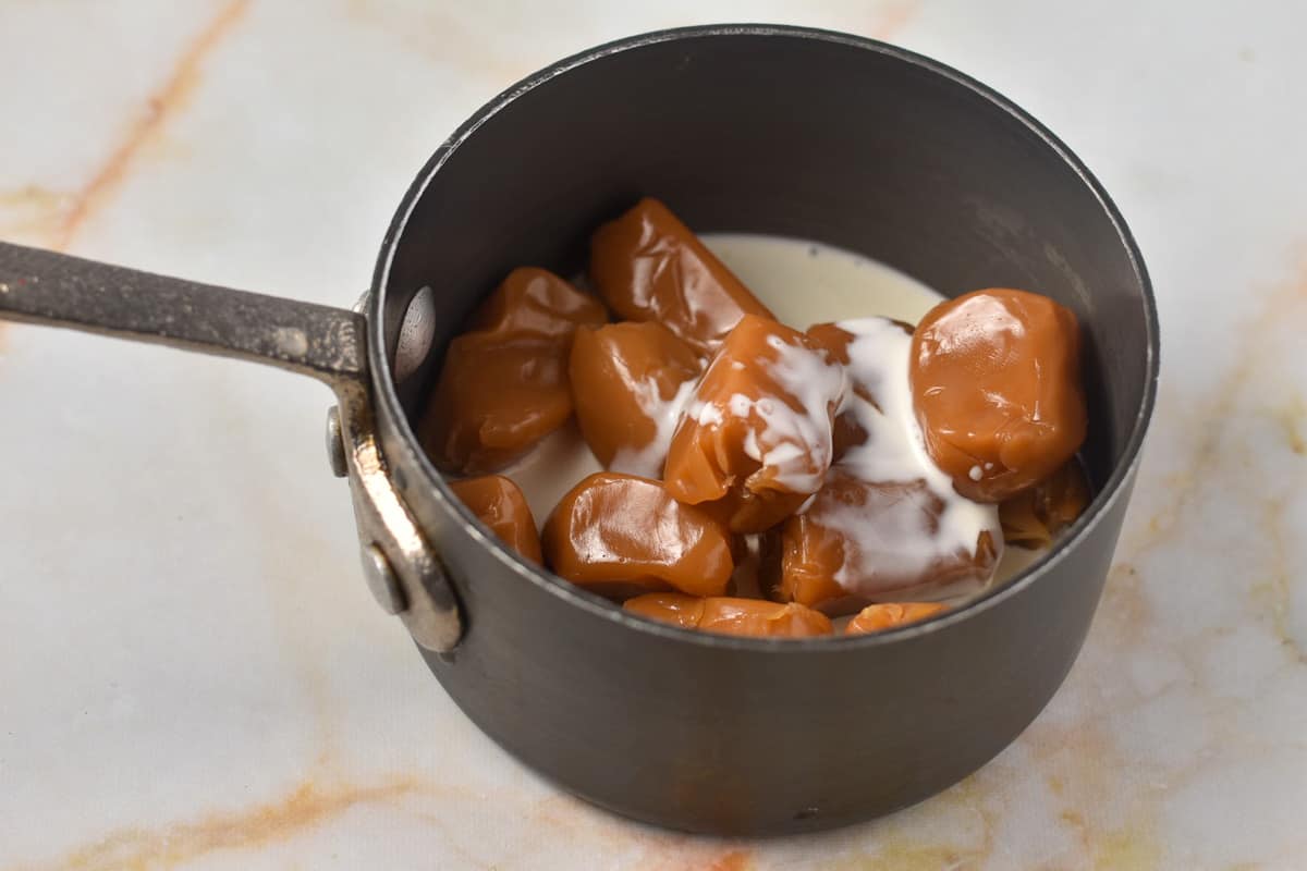 caramel and cream melting in a pot.