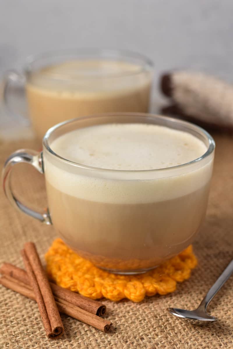 honey oatmilk latte in a clear glass.