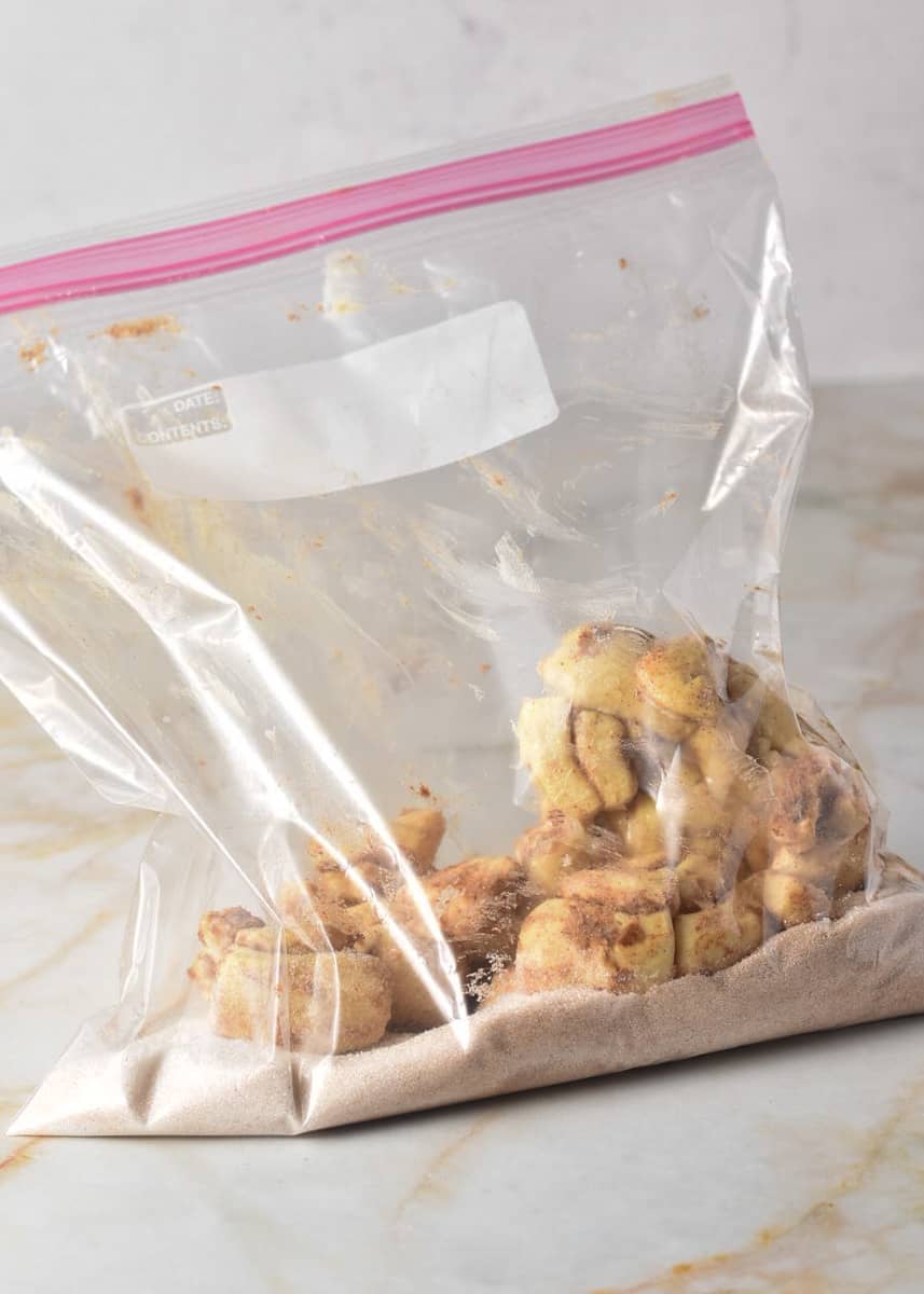 cinnamon rolls in ziplock bag with cinnamon and sugar.