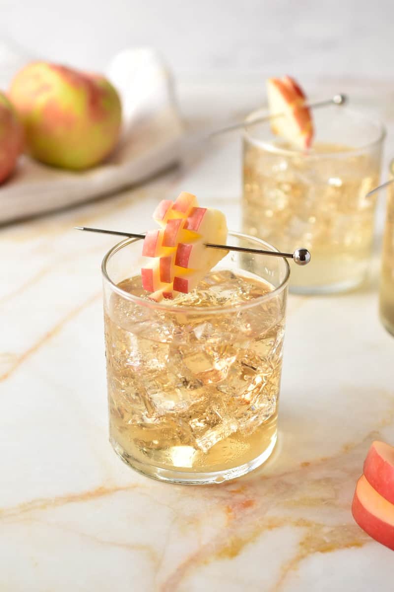 clear glass with crown apple and sprite with apple garnish.