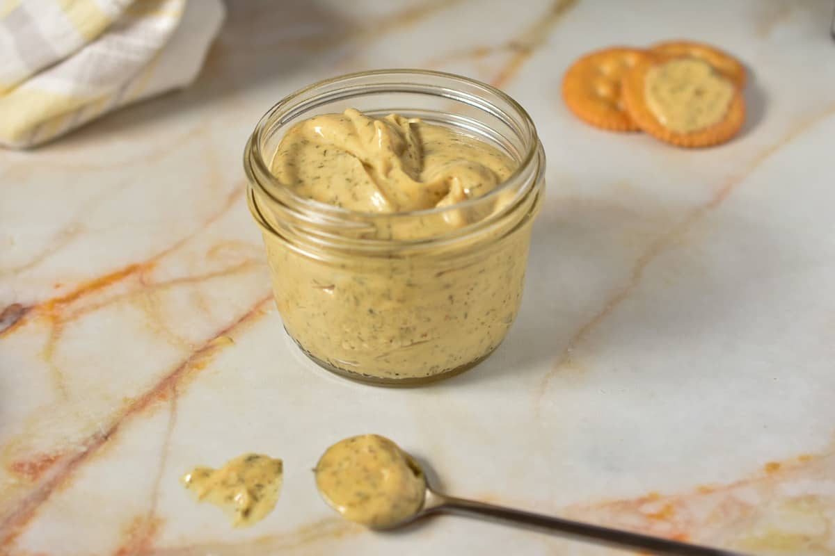 McDonald's breakfast sauce in jar with spoon and crackers.
