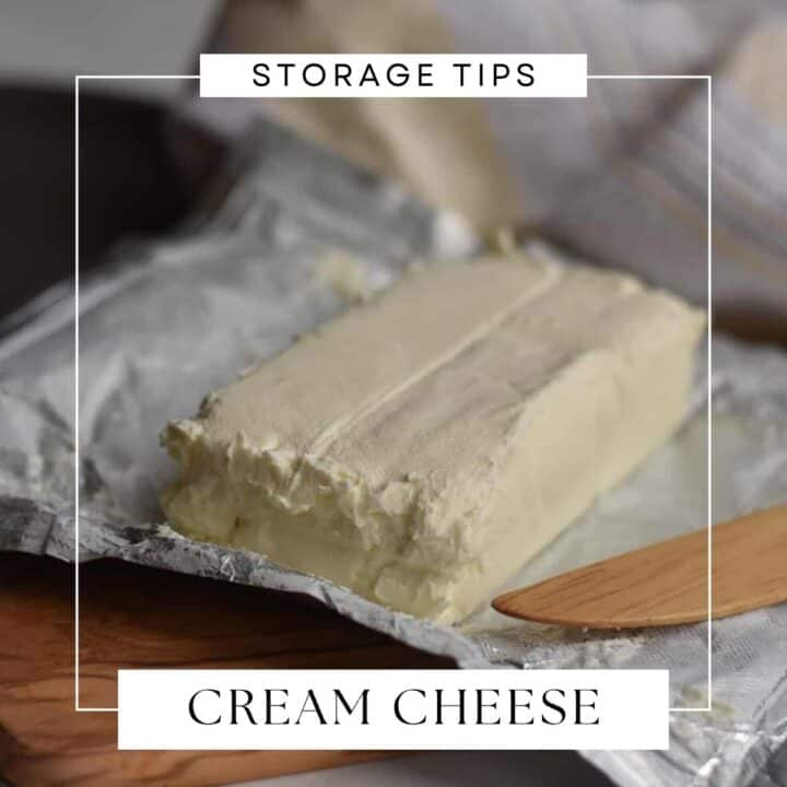 block of cream cheese sitting on a wooden cutting board.