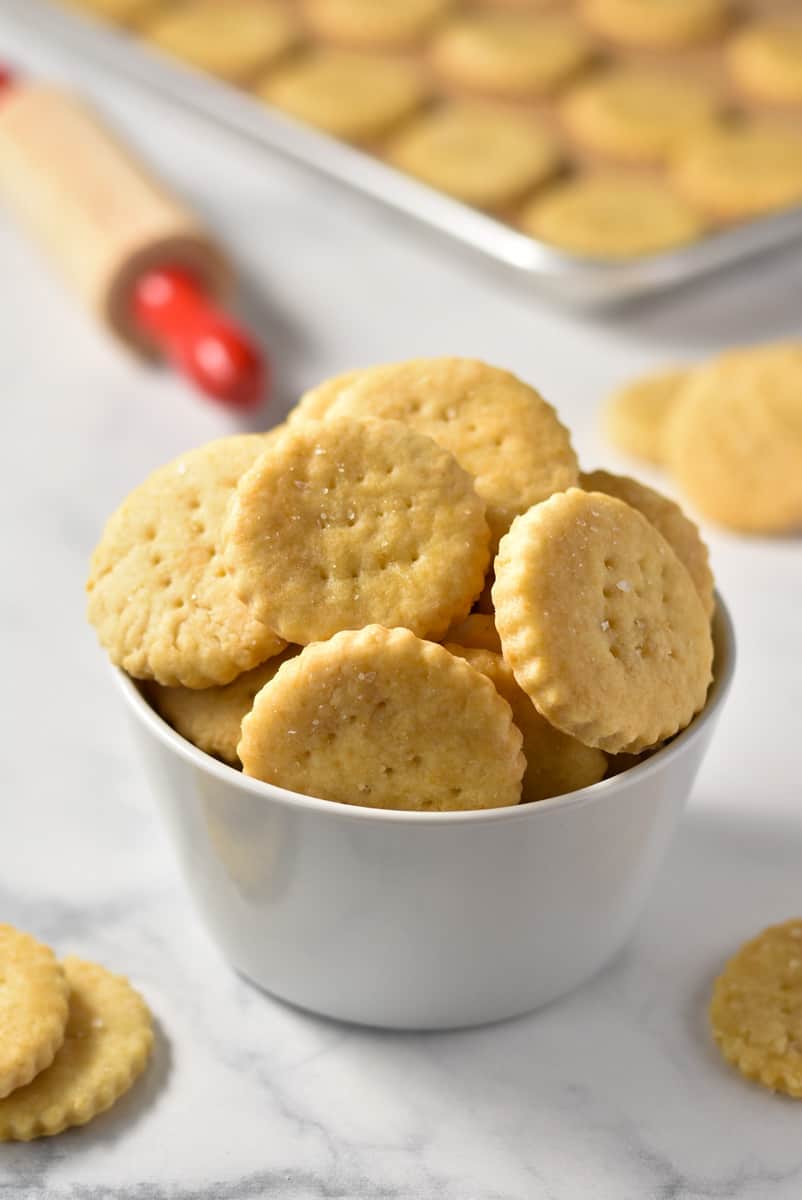 homemade ritz crackers in a bowl on the counter.