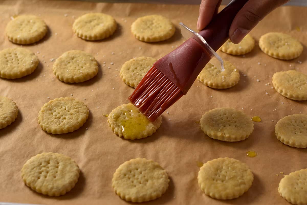 brushing oil on the homemade crackers.