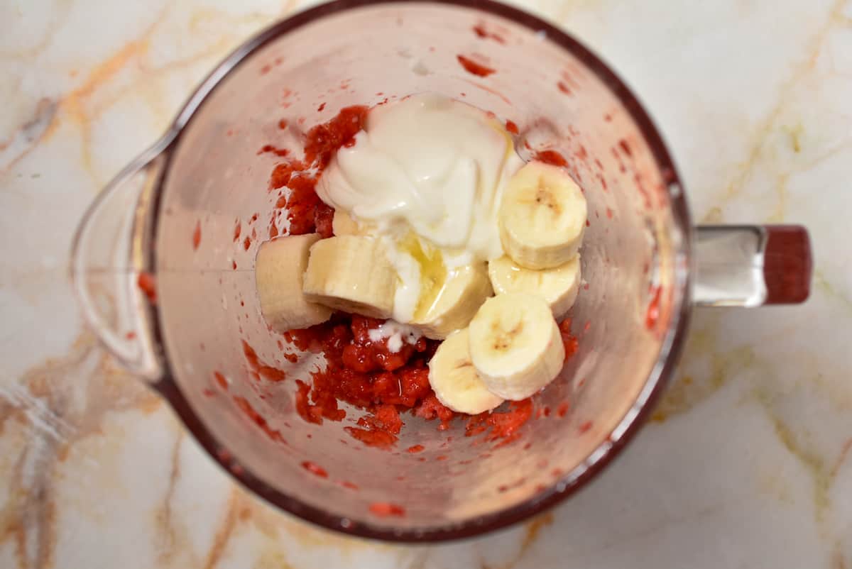 strawberries with bananas and greek yogurt in the blender. 