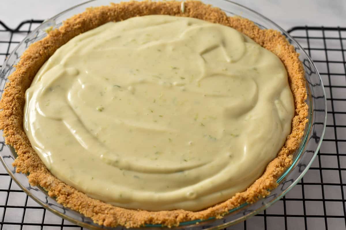 key lime filling in the crust on a wire rack.