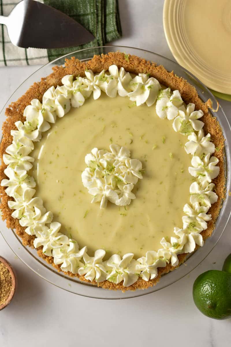 key lime pie with whipped topping garnish and lime zest.