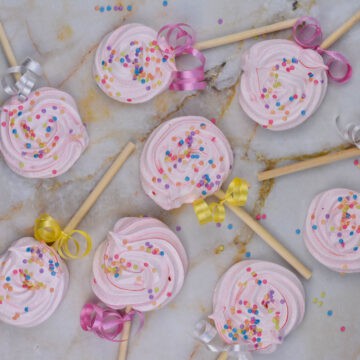 meringue cookies on a lollipop stick with sprinkles.