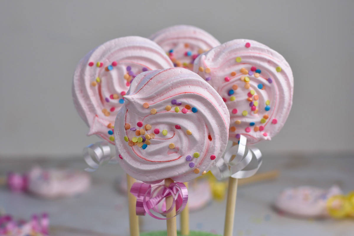 meringue pops with pink food coloring and sprinkles. 