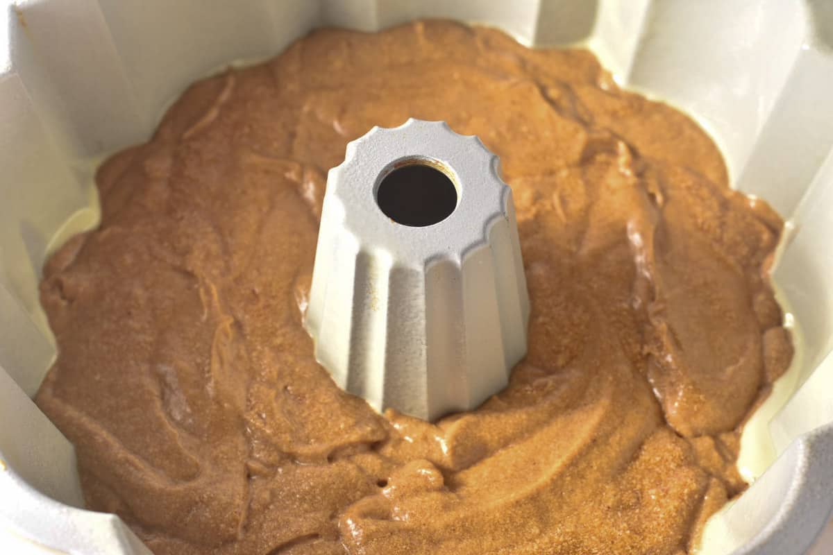cake batter smoothed into a bundt pan before baking. 