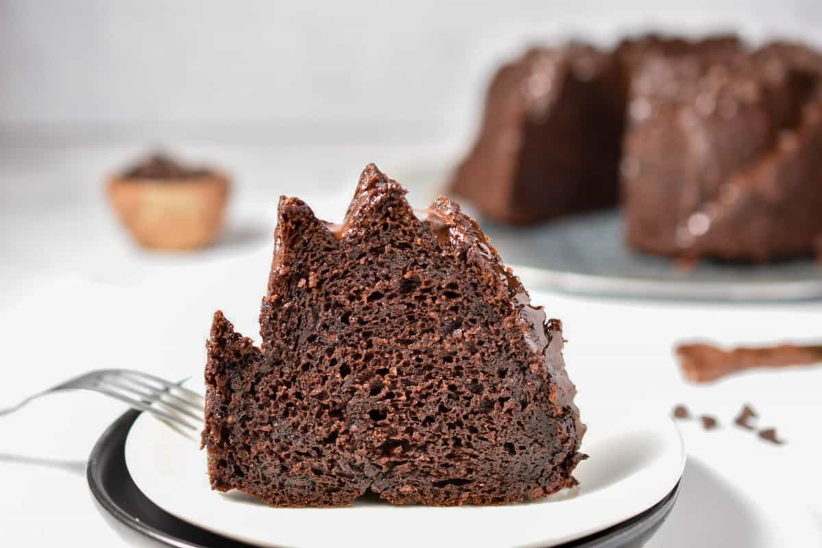 chocolate cake slice sitting up on a plate. 