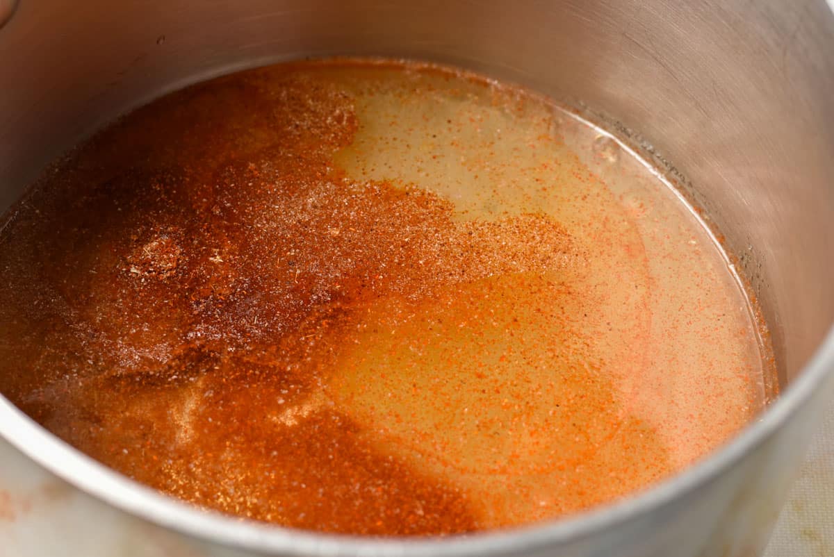 spice blend in a pot with water, oil, and vinegar. 