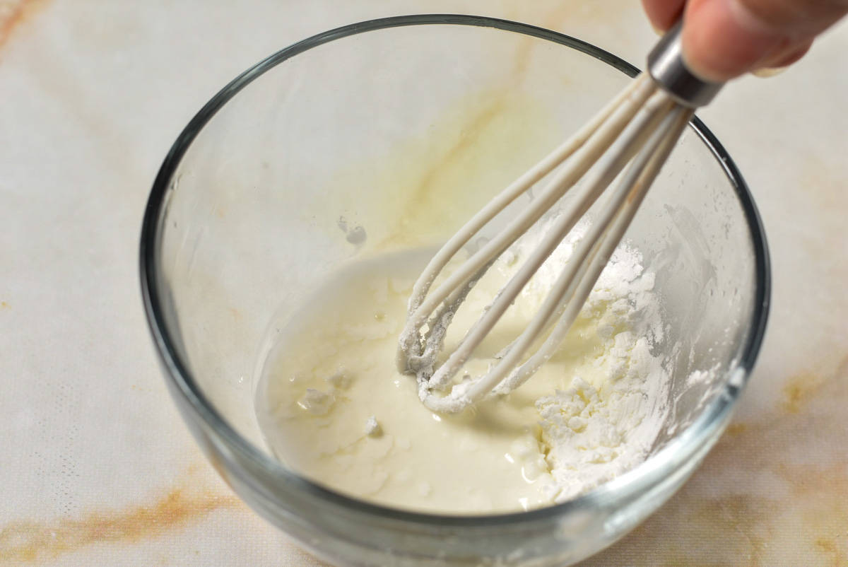 cornstarch slurry in a bowl with a whisk. 