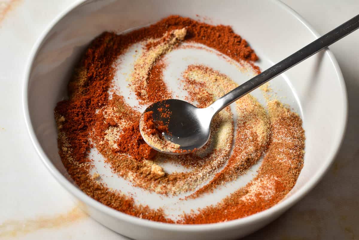chili spice blend in a bowl, including garlic powder, paprika, and cumin. 