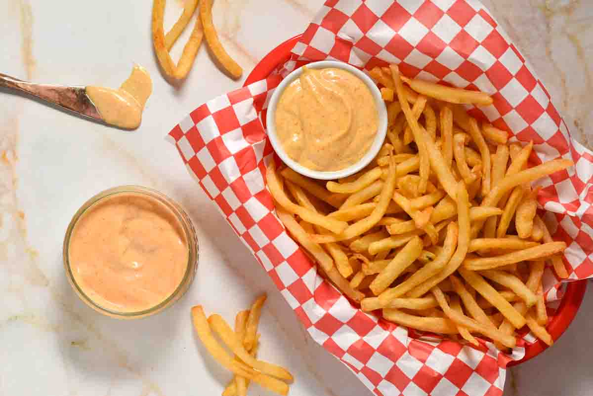 basket of French fries with a small bowl of Freddy's sauce. 