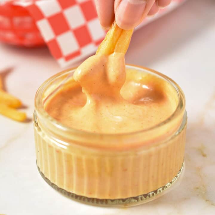 French fried dipped into a bowl of creamy fry sauce.
