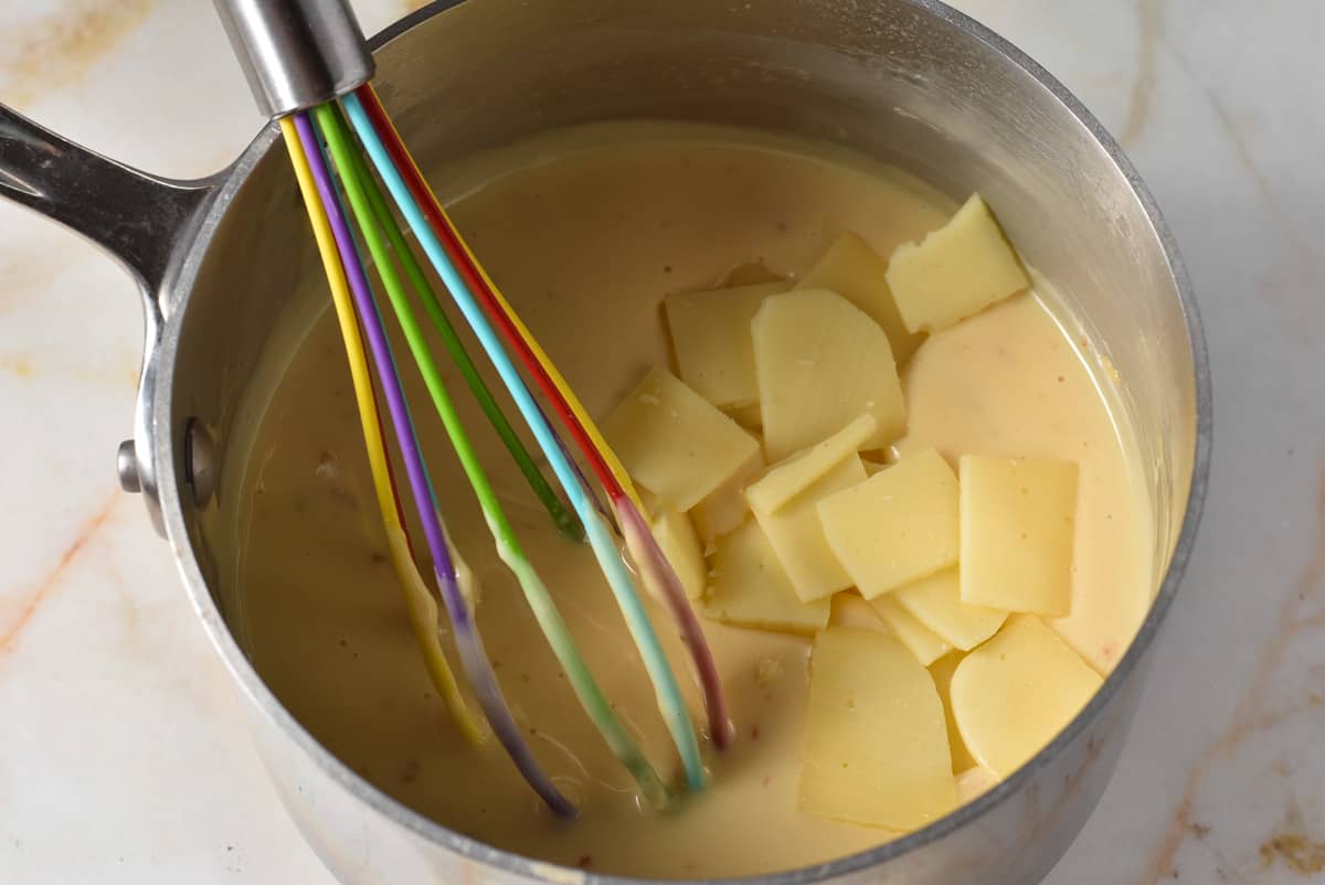 creamy cheese mixture in a pot with white american cheese added. 