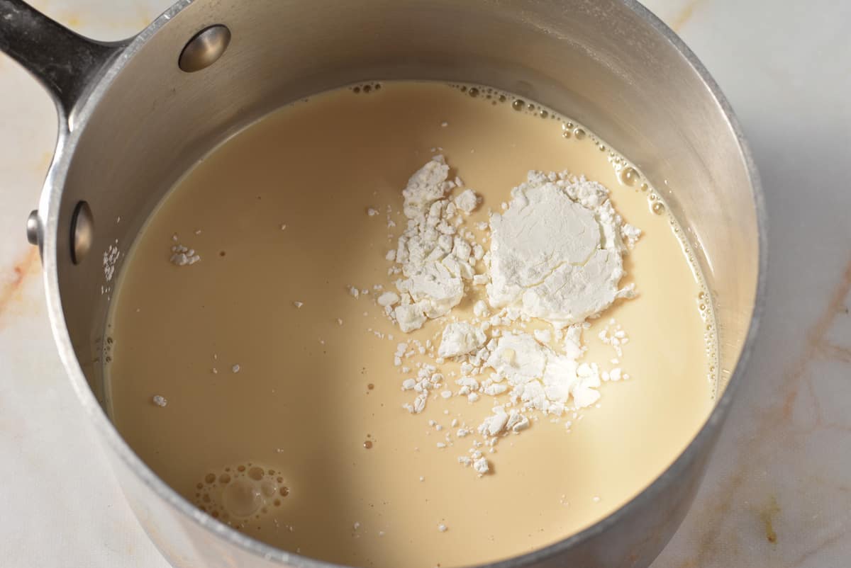 evaporated milk and cornstarch in a pot. 