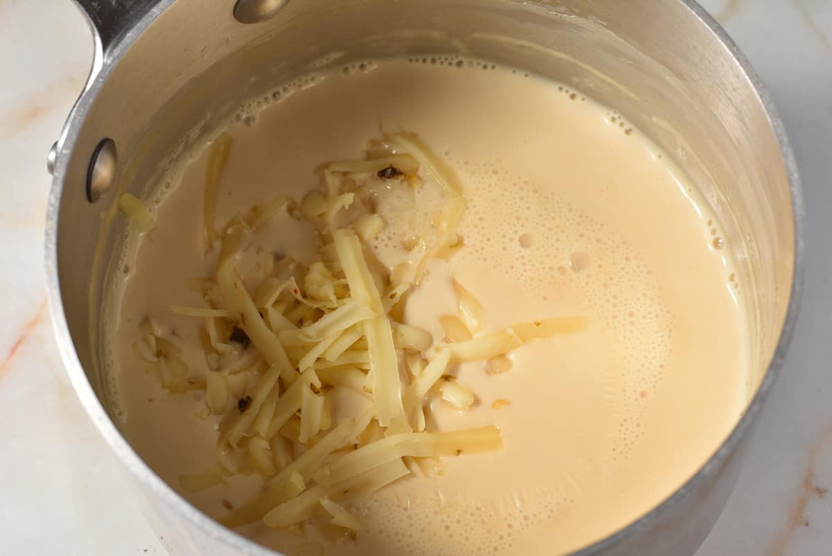 shredded pepper jack cheese in milk  mixture on the stove. 