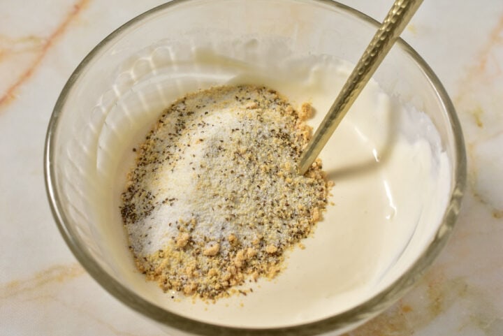 Creamy sauce and spices all combined together in a bowl.