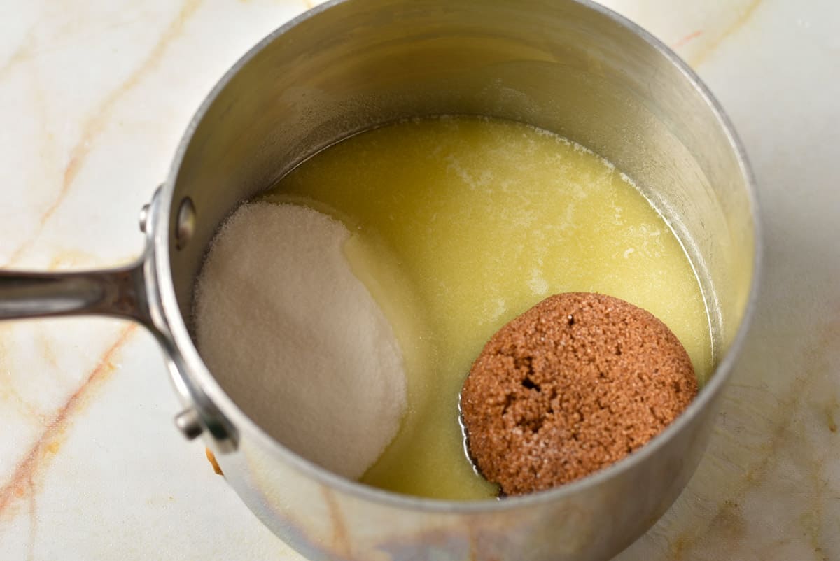 melted butter in a pan with brown sugar and white sugar. 