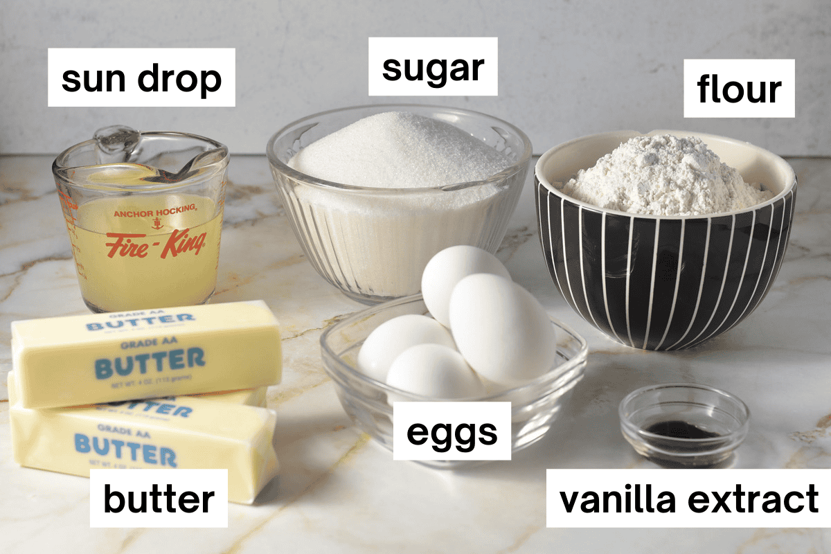 Ingredients for bundt cake, including butter soda, flour, sugar, vanilla extract.