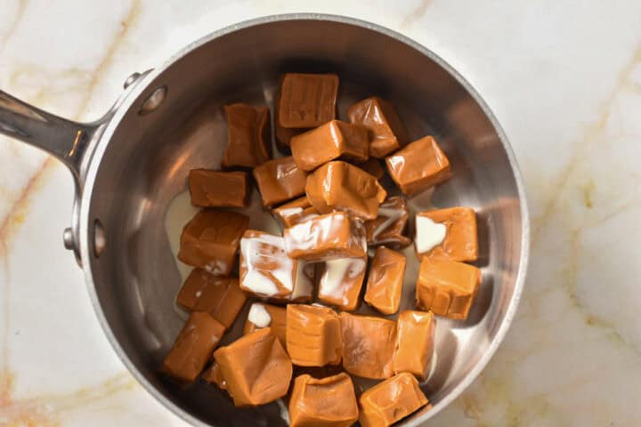 caramels in a pan with heavy cream.