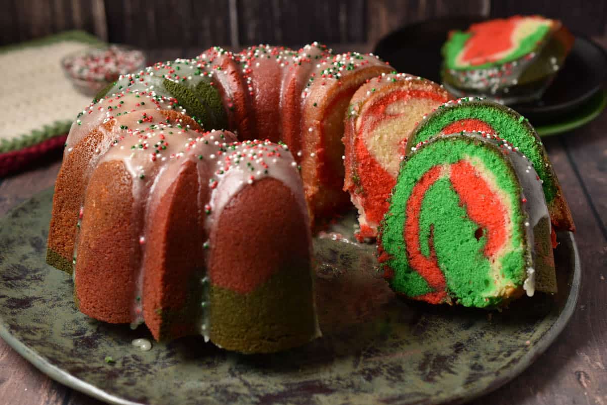 slice of Christmas bundt cake with red and green swirls.